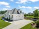 Charming home with a three-car garage, manicured lawn, and professional landscaping creating curb appeal at 1608 Legacy Ridge Ln, Wake Forest, NC 27587