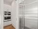 Kitchen featuring built-in double ovens, stainless steel refrigerator, and white cabinetry with gold hardware at 1608 Legacy Ridge Ln, Wake Forest, NC 27587