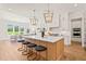 Kitchen island with seating, pendant lights, and stainless appliances at 1608 Legacy Ridge Ln, Wake Forest, NC 27587