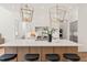 Modern kitchen featuring a large island with seating, elegant pendant lighting, and state-of-the-art appliances at 1608 Legacy Ridge Ln, Wake Forest, NC 27587