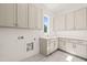 Spacious laundry room with gray cabinets, gold hardware, white countertops, and tile flooring at 1608 Legacy Ridge Ln, Wake Forest, NC 27587