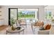 Bright living room showcasing a plush sofa, stylish chairs, and open access to the pool and outdoor living space at 1608 Legacy Ridge Ln, Wake Forest, NC 27587