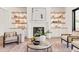 Bright and airy living room with a fireplace and built-in shelving at 1608 Legacy Ridge Ln, Wake Forest, NC 27587
