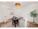 Home office featuring paneled walls, wood floors, modern lighting, and a comfortable seating area at 1608 Legacy Ridge Ln, Wake Forest, NC 27587