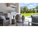 Outdoor kitchen with a grill, seating area, and a view of the backyard and pool at 1608 Legacy Ridge Ln, Wake Forest, NC 27587