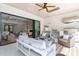 Covered outdoor living space with a ceiling fan, comfortable seating, and an outdoor kitchen area at 1608 Legacy Ridge Ln, Wake Forest, NC 27587
