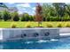 Close up of a modern pool with water features and landscaping enhancing the backyard's appeal at 1608 Legacy Ridge Ln, Wake Forest, NC 27587