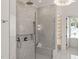 Elegant walk-in shower with gray marble tiling, a rainfall showerhead, and built-in shelving at 1608 Legacy Ridge Ln, Wake Forest, NC 27587