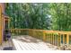 Wood deck offering ample space for outdoor enjoyment and a view of the surrounding greenery at 211 Dwelling Pl, Knightdale, NC 27545