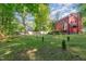 Spacious backyard featuring ample greenery, with an overview of the home's exterior and outdoor spaces at 211 Dwelling Pl, Knightdale, NC 27545