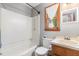 Cozy bathroom with a tub shower combo, vanity with sink, and a wood trimmed window for natural light at 211 Dwelling Pl, Knightdale, NC 27545