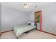 Bright bedroom features plush carpet, a ceiling fan, and a window bringing natural light and a serene atmosphere at 211 Dwelling Pl, Knightdale, NC 27545