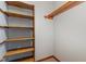 Walk in closet with wood shelving at 211 Dwelling Pl, Knightdale, NC 27545