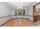 Bright dining room featuring a bay window, wood trim, and chandelier lighting at 211 Dwelling Pl, Knightdale, NC 27545