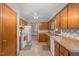 Kitchen features wooden cabinets, tiled backsplash, and white appliances at 211 Dwelling Pl, Knightdale, NC 27545