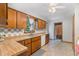 Kitchen featuring wood cabinets, tile backsplash, and double stainless steel sink at 211 Dwelling Pl, Knightdale, NC 27545