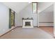 Open-concept living room with neutral walls, a fireplace, and large windows for ample sunlight at 211 Dwelling Pl, Knightdale, NC 27545