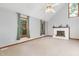 Bright living room showcasing a traditional fireplace and large windows with view to the outdoors at 211 Dwelling Pl, Knightdale, NC 27545