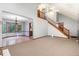 Open living space with dining area, stairs, carpeted floors, and ample natural light at 211 Dwelling Pl, Knightdale, NC 27545