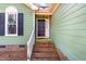 Front entrance with brick steps and white door at 2412 Faucette Ave, Durham, NC 27704