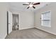 Well-lit bedroom with ceiling fan and access to another room at 257 Macallan Dr, Burlington, NC 27215