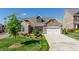 Brick house with a two-car garage and landscaped front yard at 257 Macallan Dr, Burlington, NC 27215