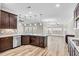 Spacious kitchen with island, stainless steel appliances, and dark wood cabinets at 257 Macallan Dr, Burlington, NC 27215