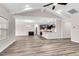 Open living room with hardwood floors, vaulted ceiling, kitchen view at 257 Macallan Dr, Burlington, NC 27215