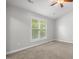 Spacious bedroom with carpeted floor and large window at 2635 Broad Oaks Pl, Raleigh, NC 27603