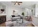 Virtually staged living room with gray sofa and fireplace at 2635 Broad Oaks Pl, Raleigh, NC 27603