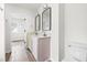 Double vanity bathroom with two mirrors and a view of another room at 2730 Erinridge Rd, Raleigh, NC 27610