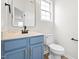 Powder room with blue vanity and modern fixtures at 2730 Erinridge Rd, Raleigh, NC 27610