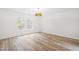 Light-filled bedroom with wood floors and a chandelier at 2730 Erinridge Rd, Raleigh, NC 27610