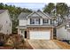 Two-story house with gray siding, stone accents, and a two-car garage at 2730 Erinridge Rd, Raleigh, NC 27610