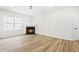 Living room with corner fireplace and wood-look floors at 2730 Erinridge Rd, Raleigh, NC 27610