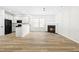 Living room with fireplace, kitchen island, and wood-look floors at 2730 Erinridge Rd, Raleigh, NC 27610