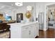 Island kitchen with white cabinetry, stainless steel appliances, and hardwood floors at 353 Murray Grey Ln, Wake Forest, NC 27587