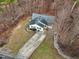 Aerial view of home with a long driveway, gray roof and wooded backyard at 501 Pearson Dr, Durham, NC 27713