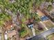 This aerial view shows the house nestled among beautiful green trees and landscaping at 501 Pearson Dr, Durham, NC 27713