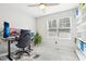Bright bedroom featuring a ceiling fan, large window and home office set up for a modern aesthetic at 501 Pearson Dr, Durham, NC 27713