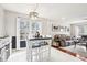 Bright dining area with modern white table, chandelier, and view into the living room at 501 Pearson Dr, Durham, NC 27713