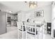 Charming kitchen with white cabinetry, tile backsplash, stainless steel appliances, and a bright dining area at 501 Pearson Dr, Durham, NC 27713