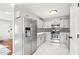 Well-lit kitchen with stainless steel appliances, white cabinets, and patterned backsplash at 501 Pearson Dr, Durham, NC 27713