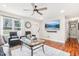 Bright living room featuring hardwood floors, ceiling fan, and a large window for ample natural light at 501 Pearson Dr, Durham, NC 27713