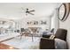 Open living room with a cozy gray sofa, wood floors, area rug, and modern ceiling fan at 501 Pearson Dr, Durham, NC 27713