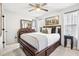 Bedroom with a dark wood bedframe, stylish furnishings, and a ceiling fan at 501 Pearson Dr, Durham, NC 27713