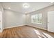 Bedroom with wood floors, a window for natural light, and a neutral palette at 5394 Salem Woods Dr # 16, Graham, NC 27253