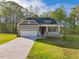 Charming single-Gathering home boasts a welcoming front porch and a well-manicured lawn at 5394 Salem Woods Dr # 16, Graham, NC 27253
