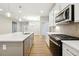 Well-designed kitchen with an island and a view to the fireplace at 5394 Salem Woods Dr # 16, Graham, NC 27253