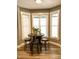Bright breakfast nook with three stools and window seating at 55 Running Deer Path, Timberlake, NC 27583